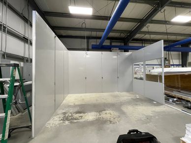 Custom modular buildings being installed inside a warehouse setting by SoFlo installations