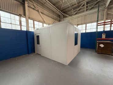A prefab modular building for shipping and receiving installed in a corner warehouse by SoFlo Instal