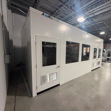 A new prefab modular office construction with doors and windows, built inside an industrial settings