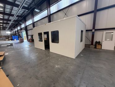 A white Prefabricated Modular Office Installation inside a warehouse setting by SoFlo installations