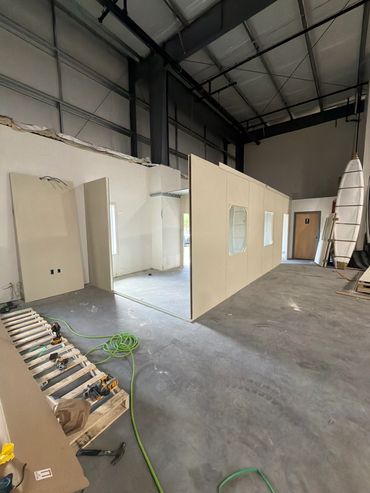 A partially done of a Modular Installations prefab building inside a warehouse setting by SoFlo
