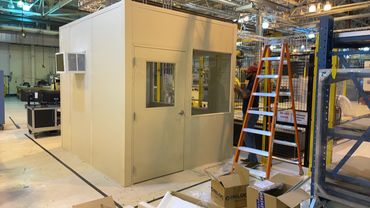 A small beige Modular Office installed inside a spacious warehouse by SoFlo Installations