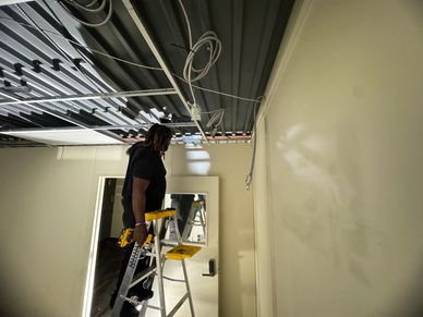 Removing the drop ceiling to start taking the prefab panels out to relocate them on a new facility.