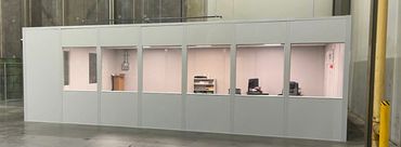 A newly constructed implant Modular Office with lights on, windows in the front. Installed by SoFlo