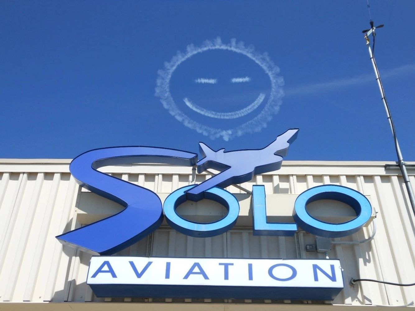 Solo Aviation logo with Skywriting Smile