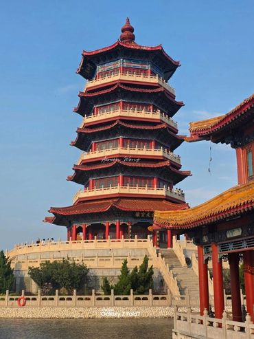 A traditional multi-tiered pagoda under a clear blue sky.