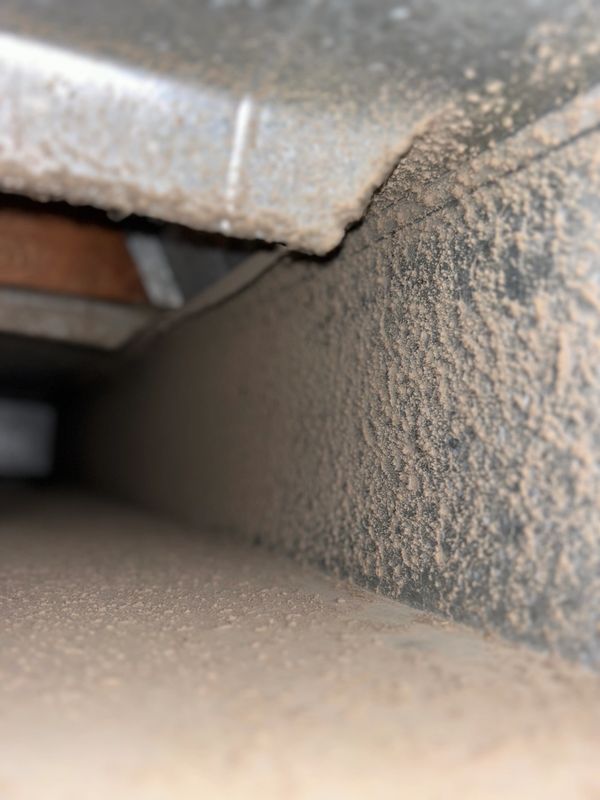 Dust buildup inside a vent or duct.