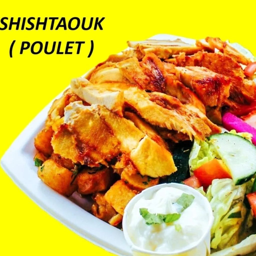 Grilled chicken shishtaouk served with fresh salad and yogurt sauce.