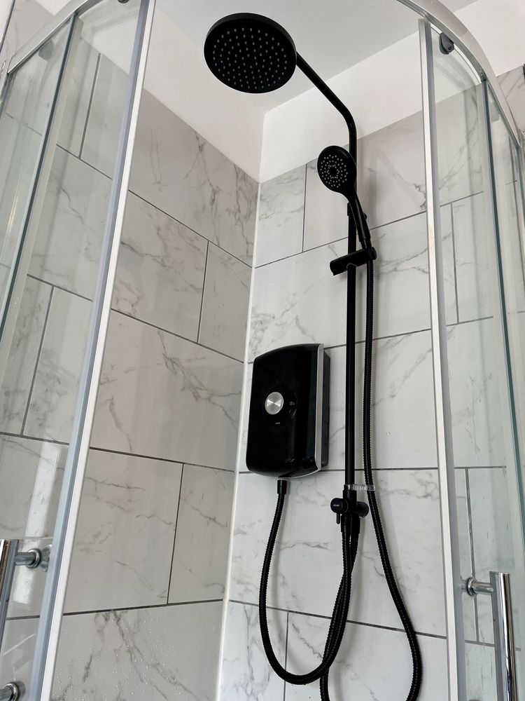 Matt black Triton electric shower with rainfall shower head