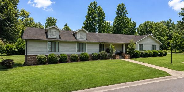 Single-story house with a well-kept lawn.