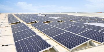 Solar panels installed on a rooftop under a clear sky.