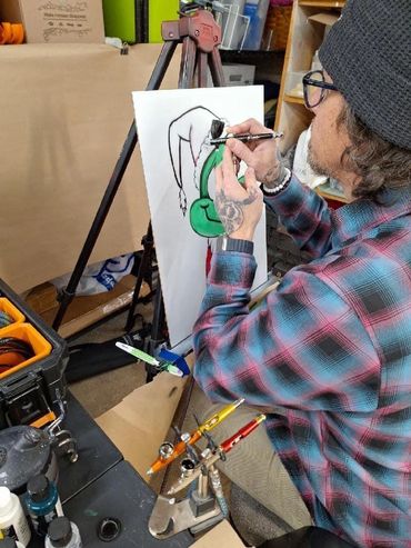 Airbrushing at an art show.