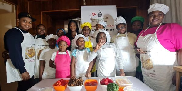 A group of children wearing chef hats and aprons at a cooking class
