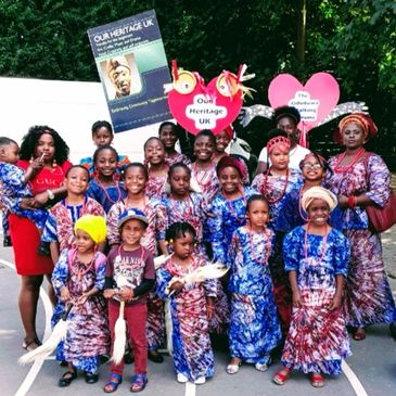Happy children in traditional clothes with some adults