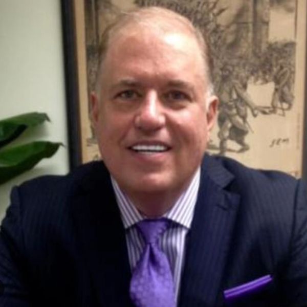 Robert Moody, CEO FSD Global; man with blue pinstripe suit purple tie, purple striped shirt headshot