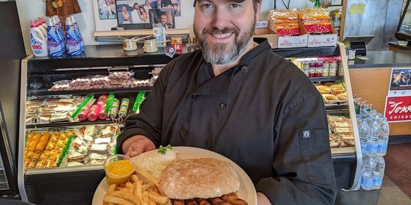 A man holding a plate full of food