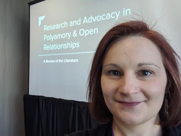 Lindsay Hayes presenting research on polyamory at a conference.