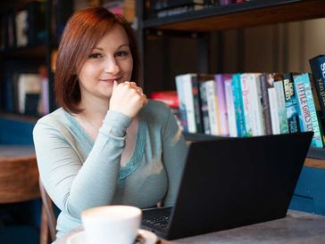 Lindsay Hayes, working on a laptop, doing research.