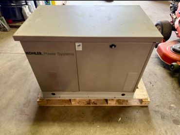 Gray Kohler Power Systems generator on a wooden pallet indoors.