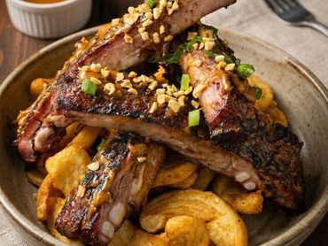 Come try our house specialty Thai sticky peanut butter ribs with battered fries.