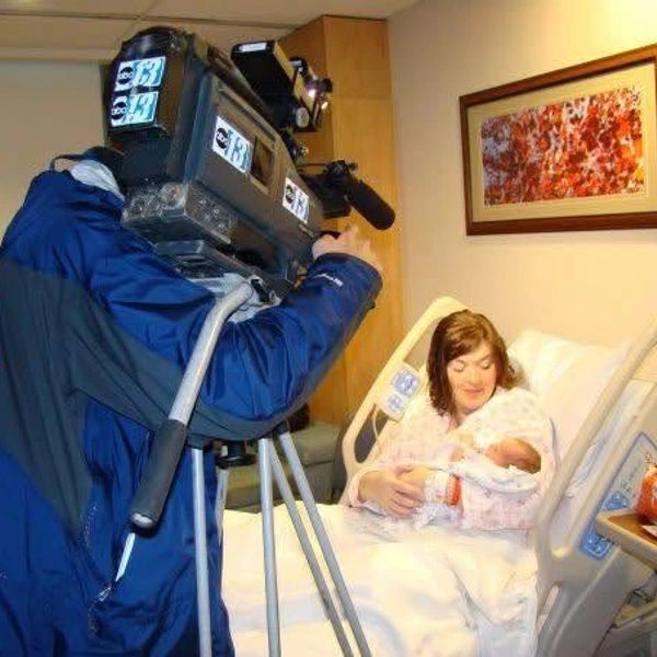 New mother in hospital bed filmed with newborn baby.