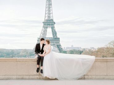 Newlyweds pose beneath the Eiffel Tower in Paris after a dreamy elopement and wedding shoot