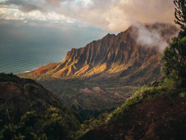 Lush Hawaiian mountain range at sunrise, ideal for scenic hikes and island adventure getaways