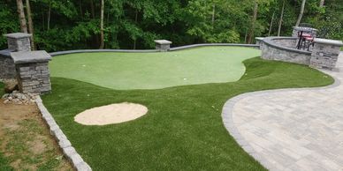 Synthetic putting greens in backyard