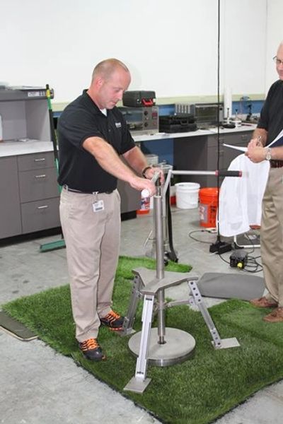 ShawSports employee performing an HAC test, to see the shock absorption.