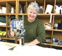 Deanna Conrad running industrial fabric saw at Kennedy Specialty Sewing Limited