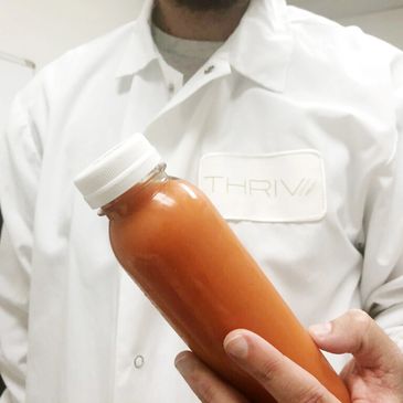 Employee showing cold-pressed juice.