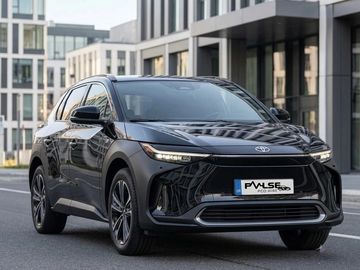 Black Toyota electric SUV parked on a city street.