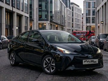 Black Toyota Prius parked on a city street.