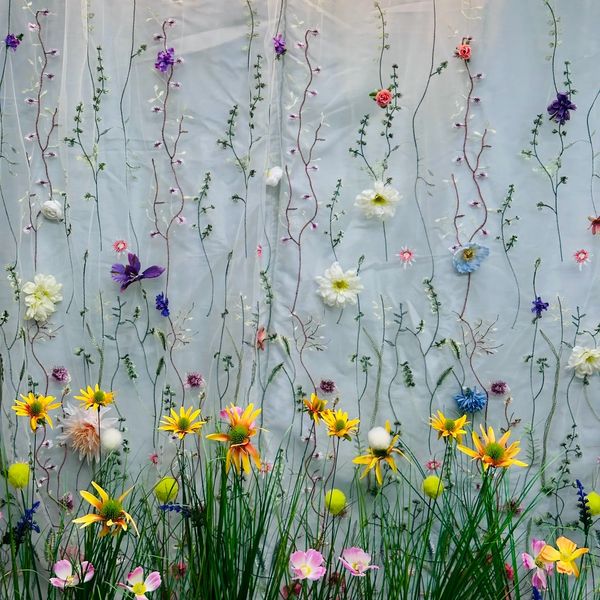 A floral backdrop with the neon sign "Snap That Smile."