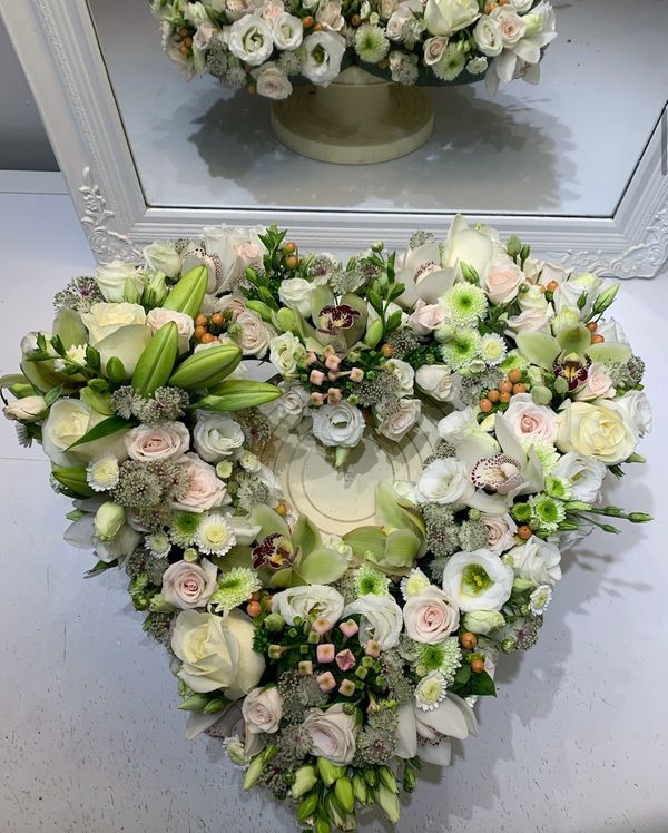 white rose funeral open heart flower arrangement
