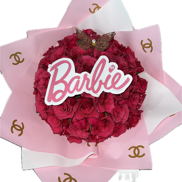 Bouquet of red roses with a Barbie sign and butterfly on pink wrapping.