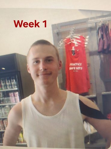 A man in white shirt and black shorts.