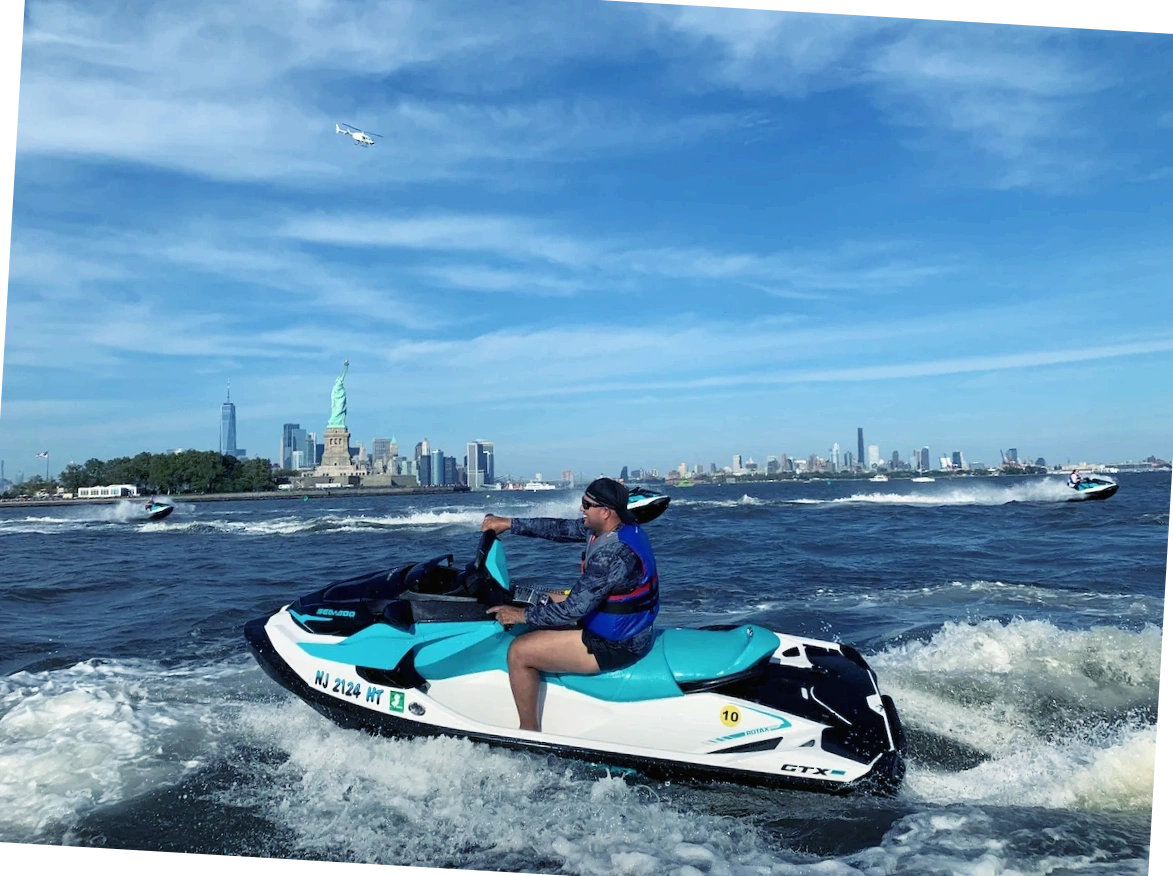 Guy driving Seadoo with friends while jet skiing next to the Statue of Liberty NYC Tours and Rentals