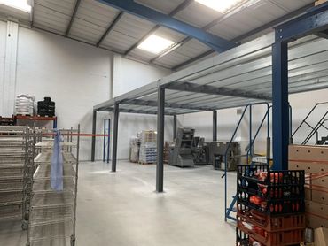 Industrial warehouse interior with metal shelving and equipment. Mezzanine Floor Manchester