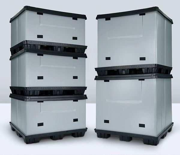Stacked grey plastic storage containers with black bases.