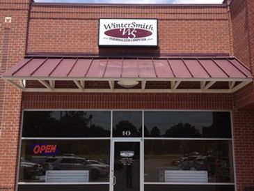 Front view of WinterSmith Technology Center storefront with open sign.