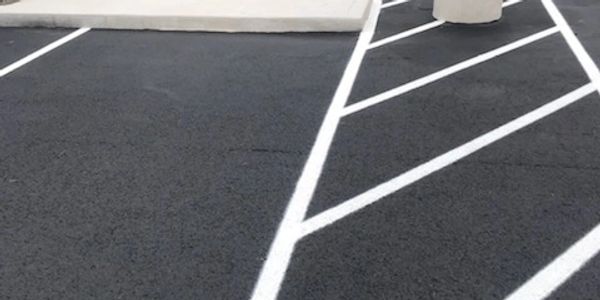 <img src="thumbnail_IMG_3896.jpg" alt="newly laid asphalt with clean striping lines"