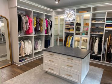 Custom walk-in closet with island storage designed by LDC Builds.