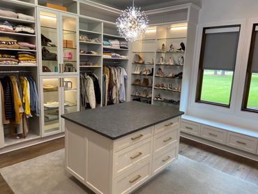 Spacious custom closet with built-in shelving and center island designed by LDC for everyday comfort