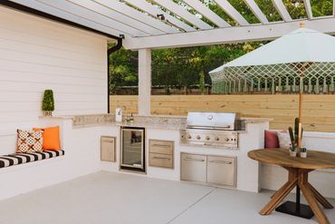 Outdoor kitchen with built -in grill and entertainment space for hosting and everyday enjoyment