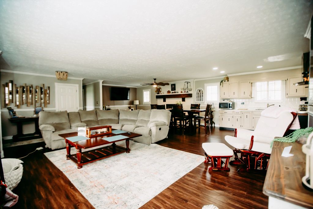Spacious living room with beige sectional sofa and wooden coffee table on a light rug.