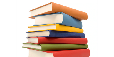 Stack of colorful hardcover books on a white background.