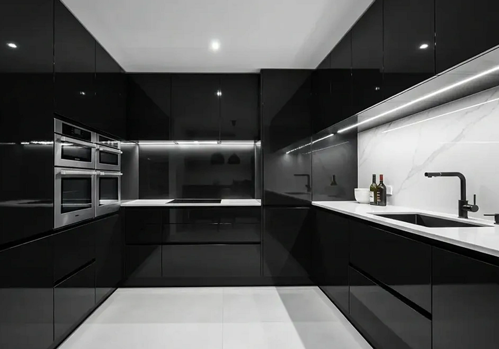 Gloss royal black slab door kitchen with white backsplash and counter top