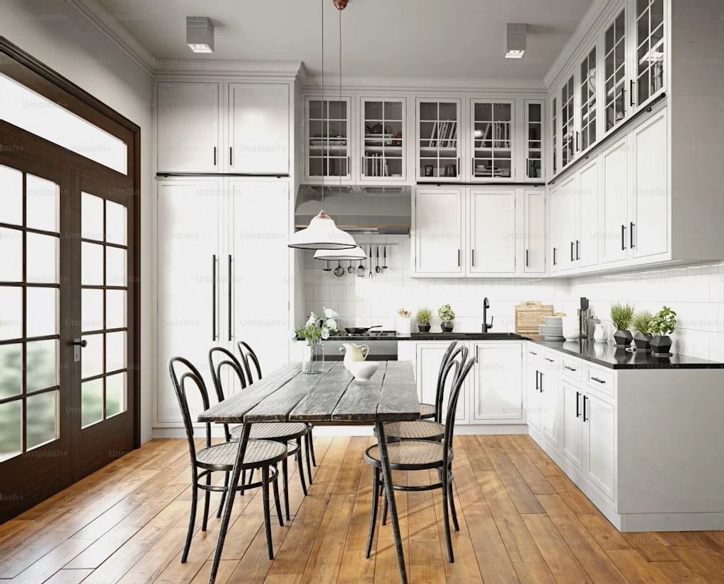 Inset shaker white kitchen with wood flooring and black granite countertop