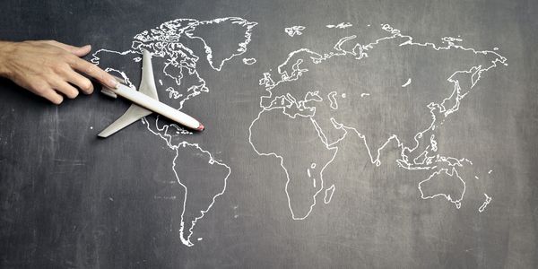 Model aircraft on a picture of the world map